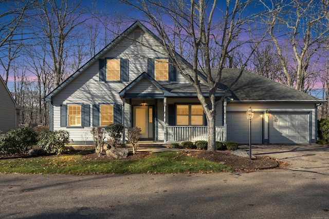 view of front property featuring covered porch and a garage