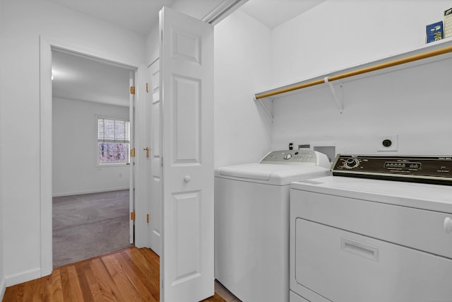 laundry area featuring light wood-type flooring and washing machine and dryer