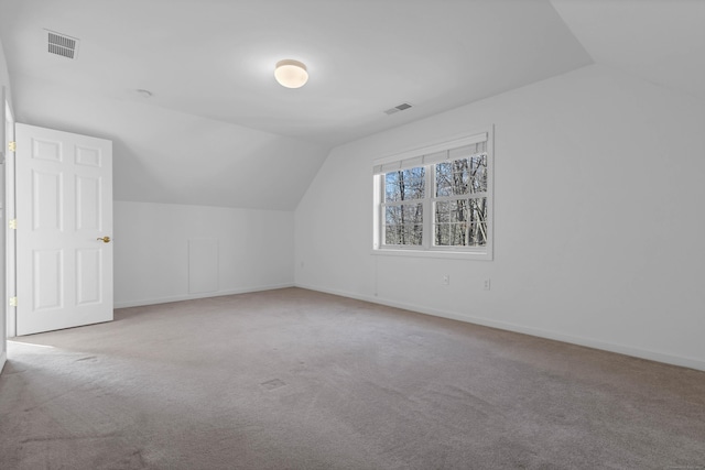 additional living space with light carpet and lofted ceiling