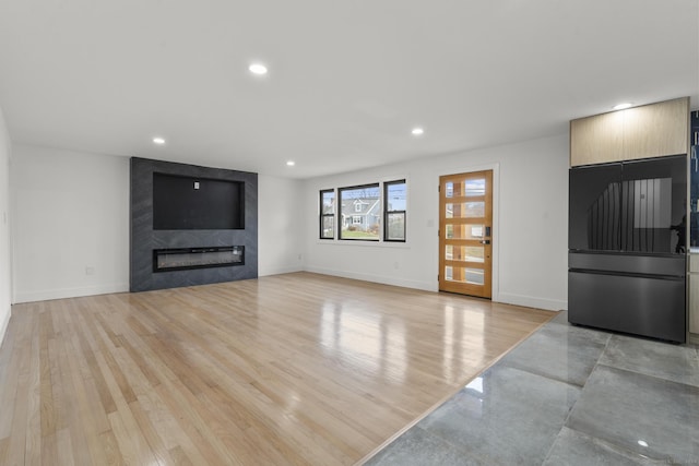 living room featuring light wood-type flooring and a fireplace