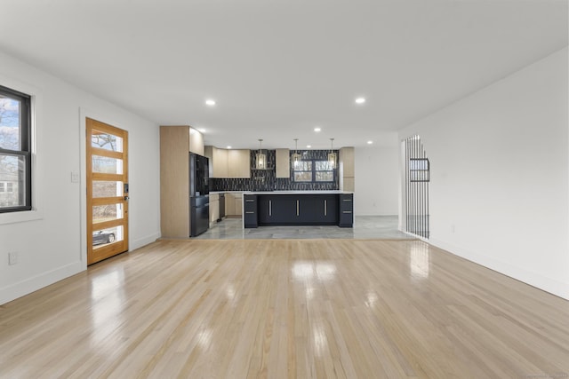 unfurnished living room featuring light hardwood / wood-style floors