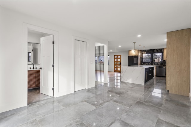 unfurnished living room featuring sink