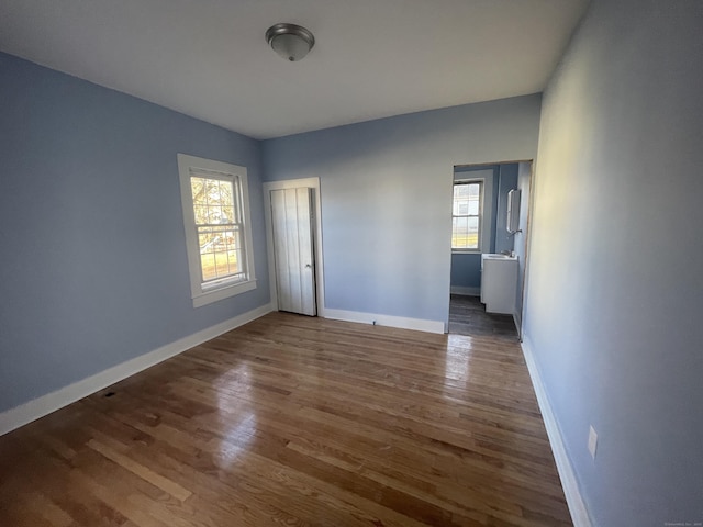 unfurnished room with dark hardwood / wood-style floors