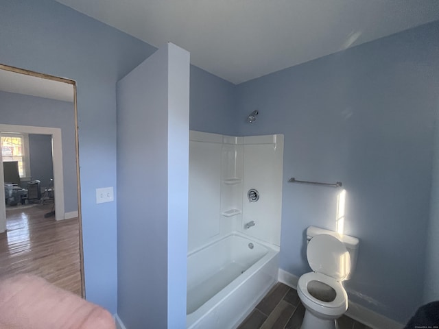 bathroom featuring toilet, wood-type flooring, and tub / shower combination