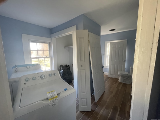 washroom with dark hardwood / wood-style floors and washer / dryer