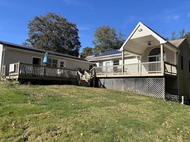 rear view of property with a yard and a deck