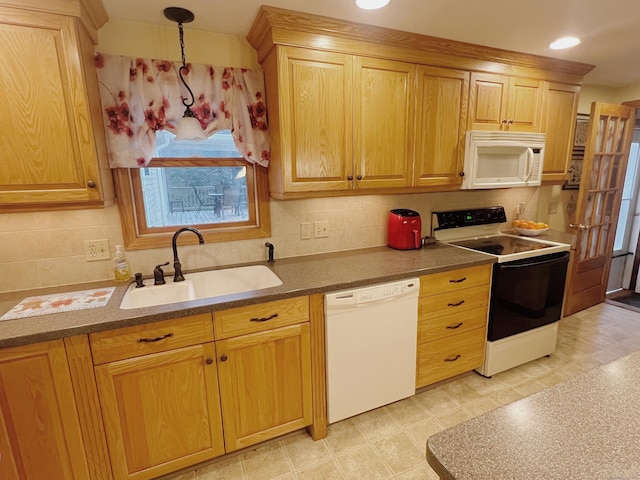 kitchen featuring pendant lighting, white appliances, tasteful backsplash, and sink