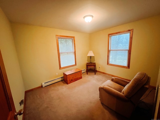 living area featuring carpet floors and a baseboard heating unit