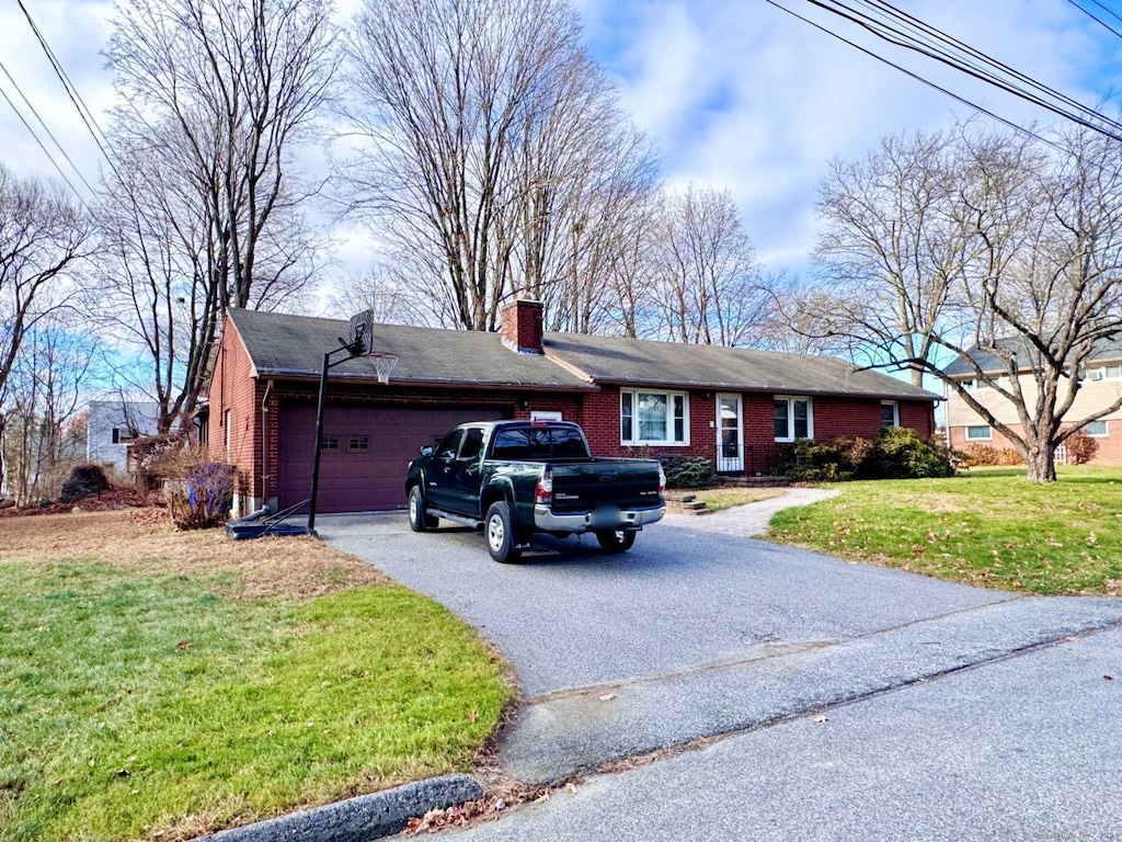 single story home featuring a front yard and a garage