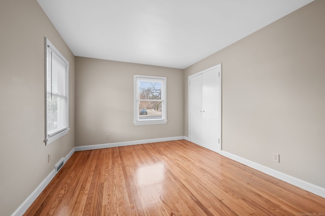 spare room with light hardwood / wood-style flooring