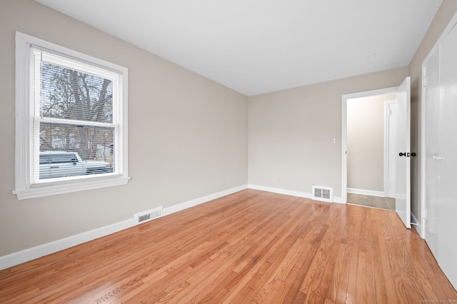 empty room with light hardwood / wood-style flooring