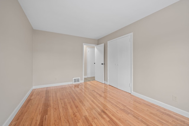 empty room with light hardwood / wood-style floors