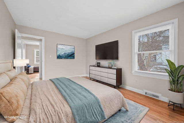 bedroom with light wood-type flooring