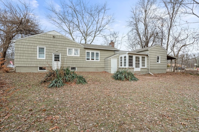 rear view of property with a carport