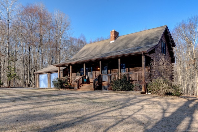 view of front facade featuring a porch and a garage