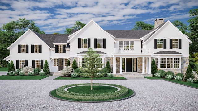 view of front of house featuring a balcony, stone siding, a chimney, curved driveway, and roof with shingles