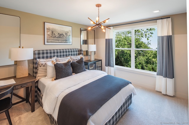 carpeted bedroom with baseboards and a chandelier