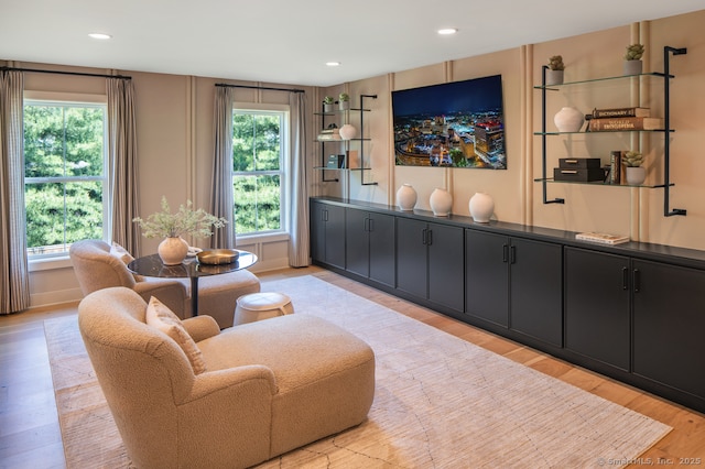 sitting room featuring recessed lighting, light wood-type flooring, and a healthy amount of sunlight