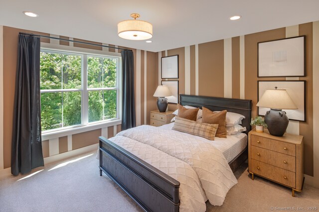 bedroom with light carpet, wallpapered walls, and recessed lighting