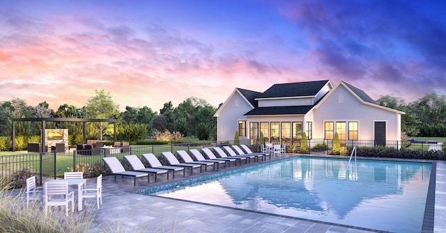 pool with fence and a patio