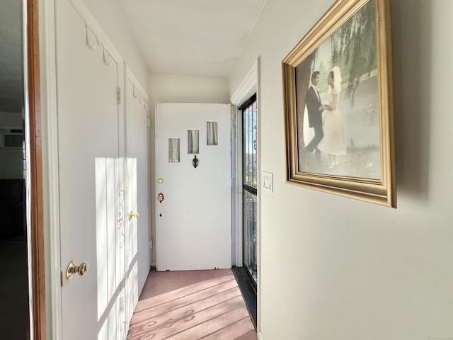 hallway with light colored carpet