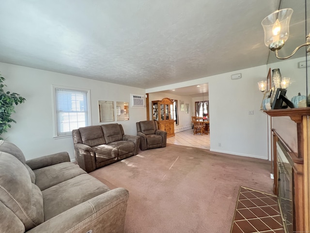 carpeted living room featuring a textured ceiling, a fireplace, a baseboard radiator, and a wall mounted AC