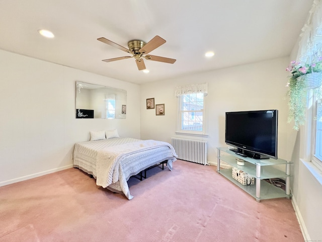 carpeted bedroom featuring radiator and ceiling fan