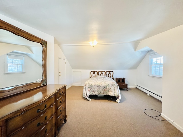 bedroom featuring vaulted ceiling, baseboard heating, light carpet, and multiple windows