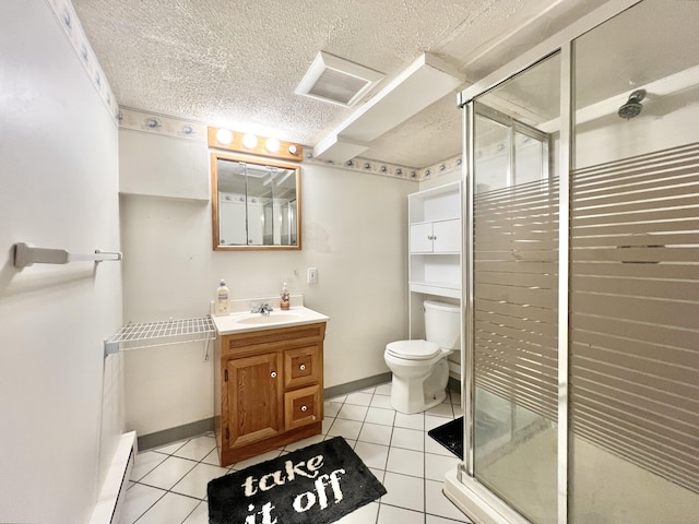 bathroom featuring toilet, vanity, tile patterned floors, and walk in shower