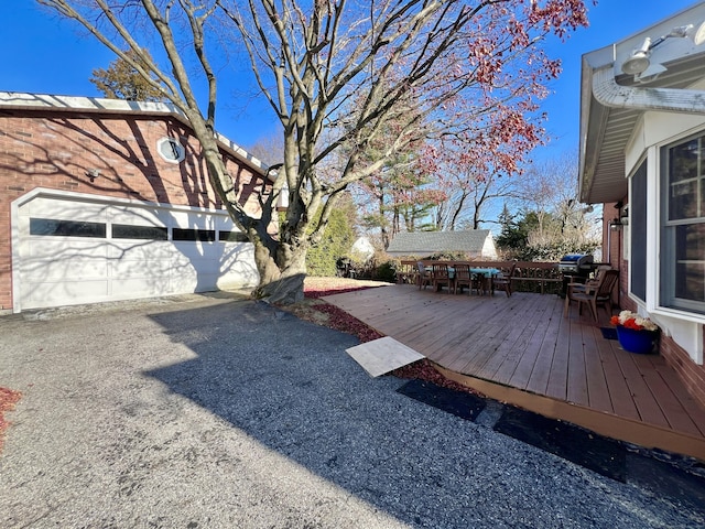 view of yard with a deck and a garage