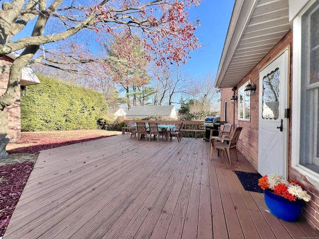 wooden deck with a grill