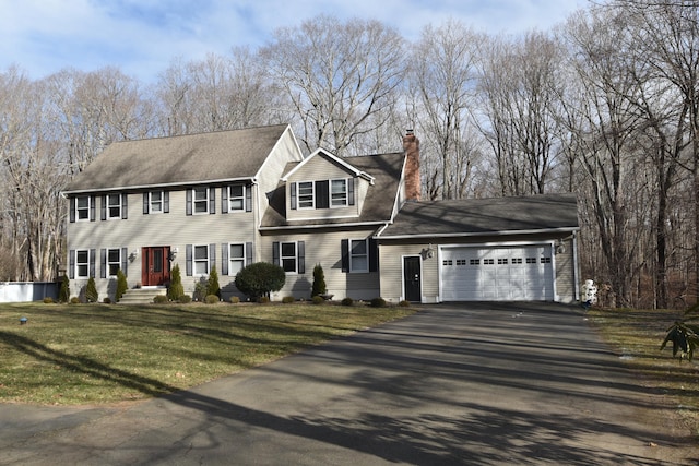 view of front of home featuring a garage and a front yard