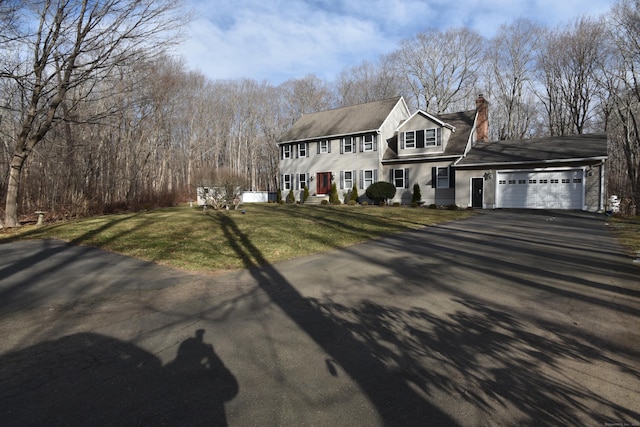 view of front of property featuring a garage and a front yard