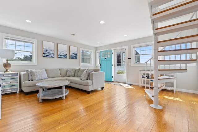 living room with a wealth of natural light and light hardwood / wood-style flooring