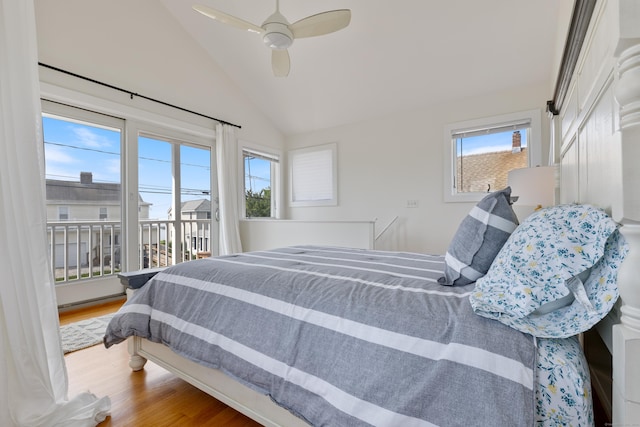 bedroom with multiple windows, wood-type flooring, ceiling fan, and lofted ceiling