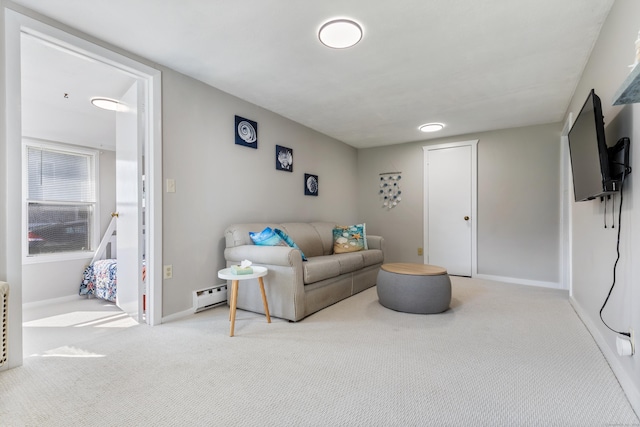 carpeted living room with a baseboard heating unit