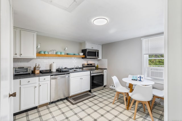 kitchen with sink, stainless steel appliances, backsplash, cooling unit, and white cabinets