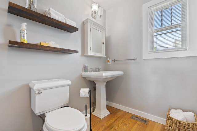 bathroom featuring hardwood / wood-style floors, toilet, and sink