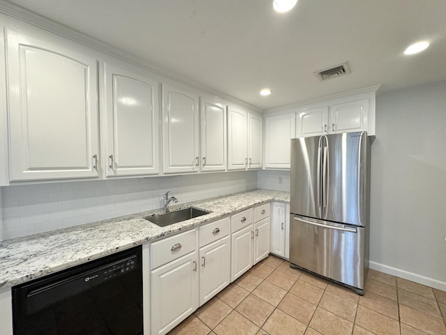 kitchen with dishwasher, backsplash, sink, white cabinetry, and stainless steel refrigerator