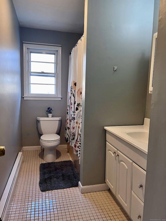 bathroom with a baseboard radiator, vanity, toilet, and tile patterned flooring