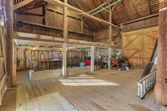 misc room featuring hardwood / wood-style flooring and high vaulted ceiling