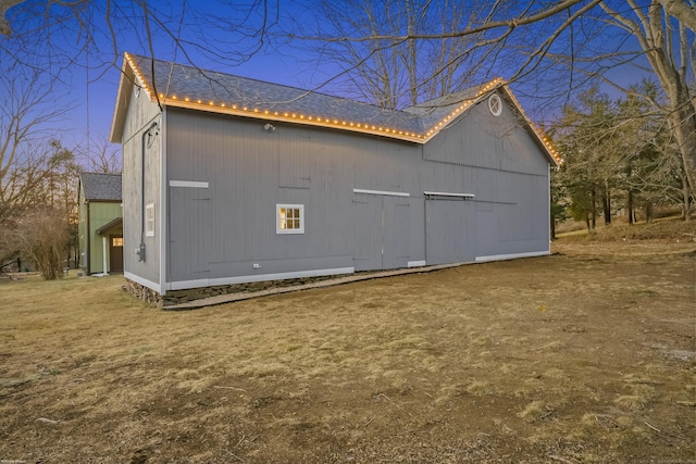 view of home's exterior with a shingled roof