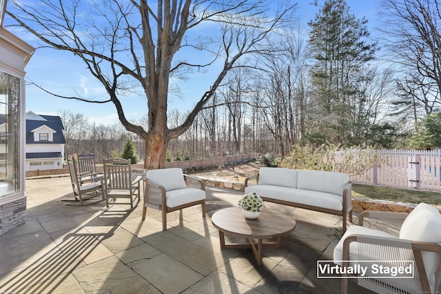 view of patio with an outdoor hangout area and fence