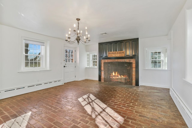 unfurnished living room with a healthy amount of sunlight, a brick fireplace, a baseboard radiator, and baseboard heating