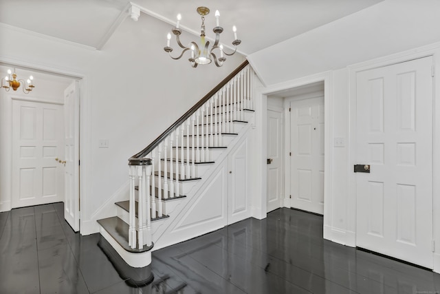 stairs with lofted ceiling, an inviting chandelier, and baseboards