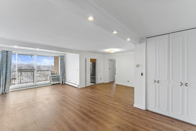 unfurnished living room featuring hardwood / wood-style floors and a baseboard radiator