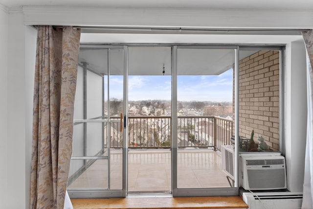 doorway to outside featuring wood-type flooring and a baseboard heating unit