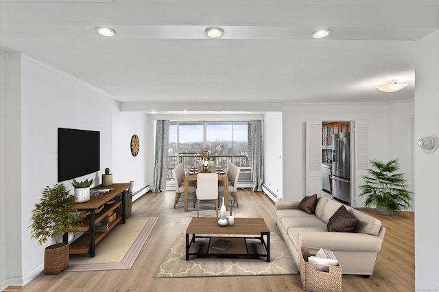 living room featuring light wood-type flooring, a baseboard radiator, and ornamental molding