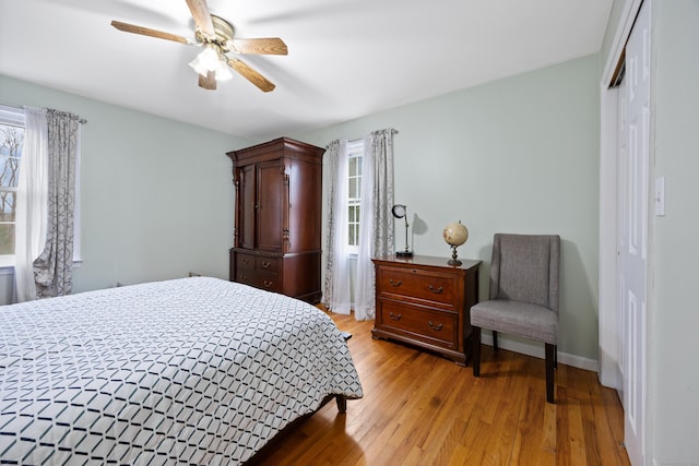 bedroom with a closet, ceiling fan, and light hardwood / wood-style flooring