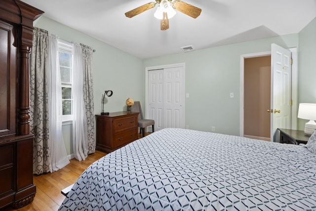 bedroom with light wood-type flooring, a closet, and ceiling fan